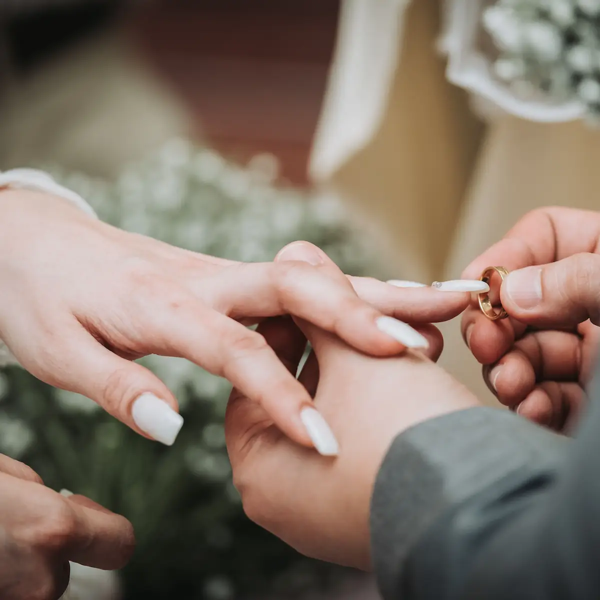 man woman putting on wedding rings after prenup concept