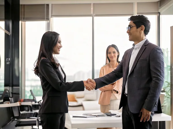 calm peaceful scene modern bright office couple smiling shaking hands