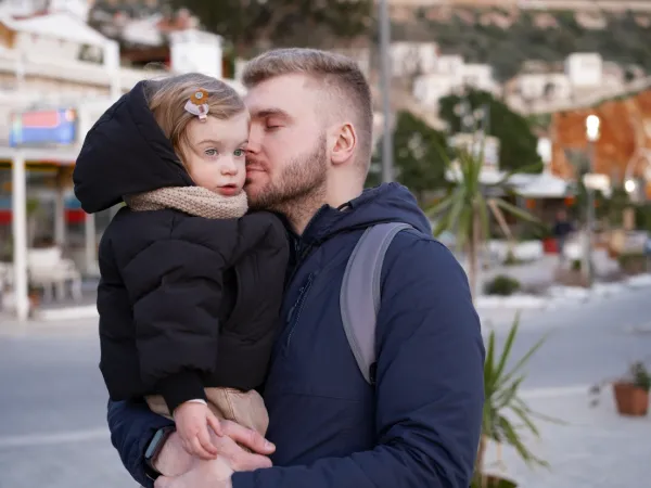 man kissing baby girl international divorce concept